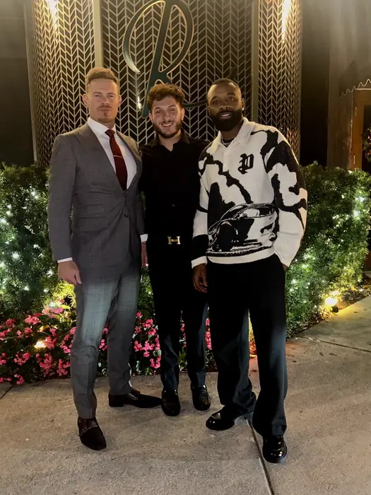 Three people photographed together at a brand event
