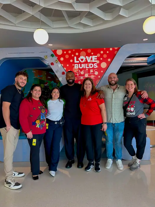 Team gathered together at a community partnership event