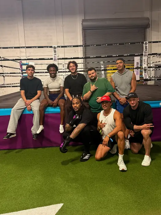 Group gathered on a turf training field after a session